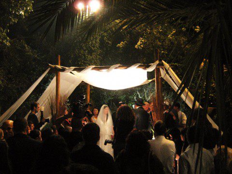 In this ceremony the couple and the clergyman stand under a canopy which 