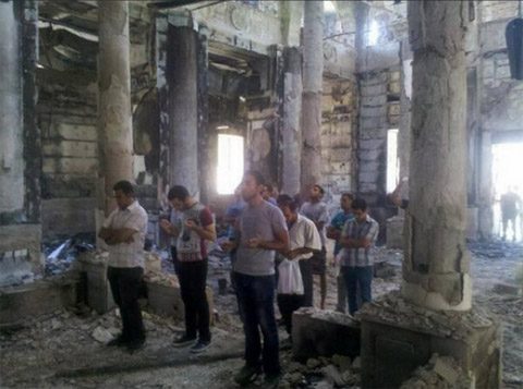Copts worship in their burned out church sanctuary.