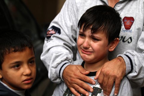 A Christian child weeps for his slain family
